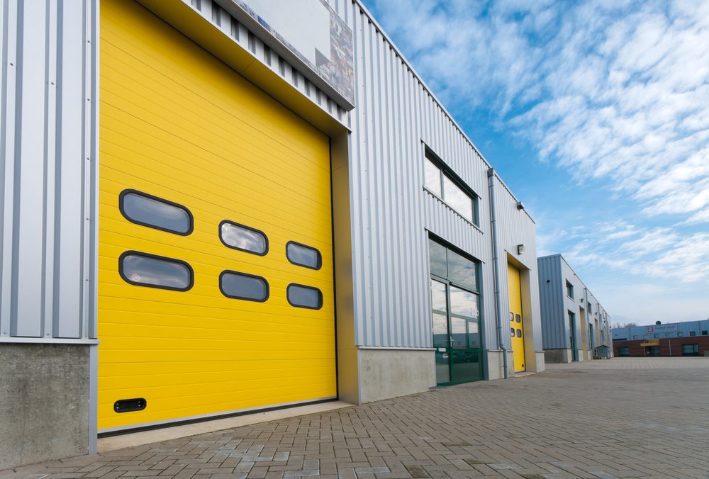 Industrial warehouse with yellow roller shutter doors